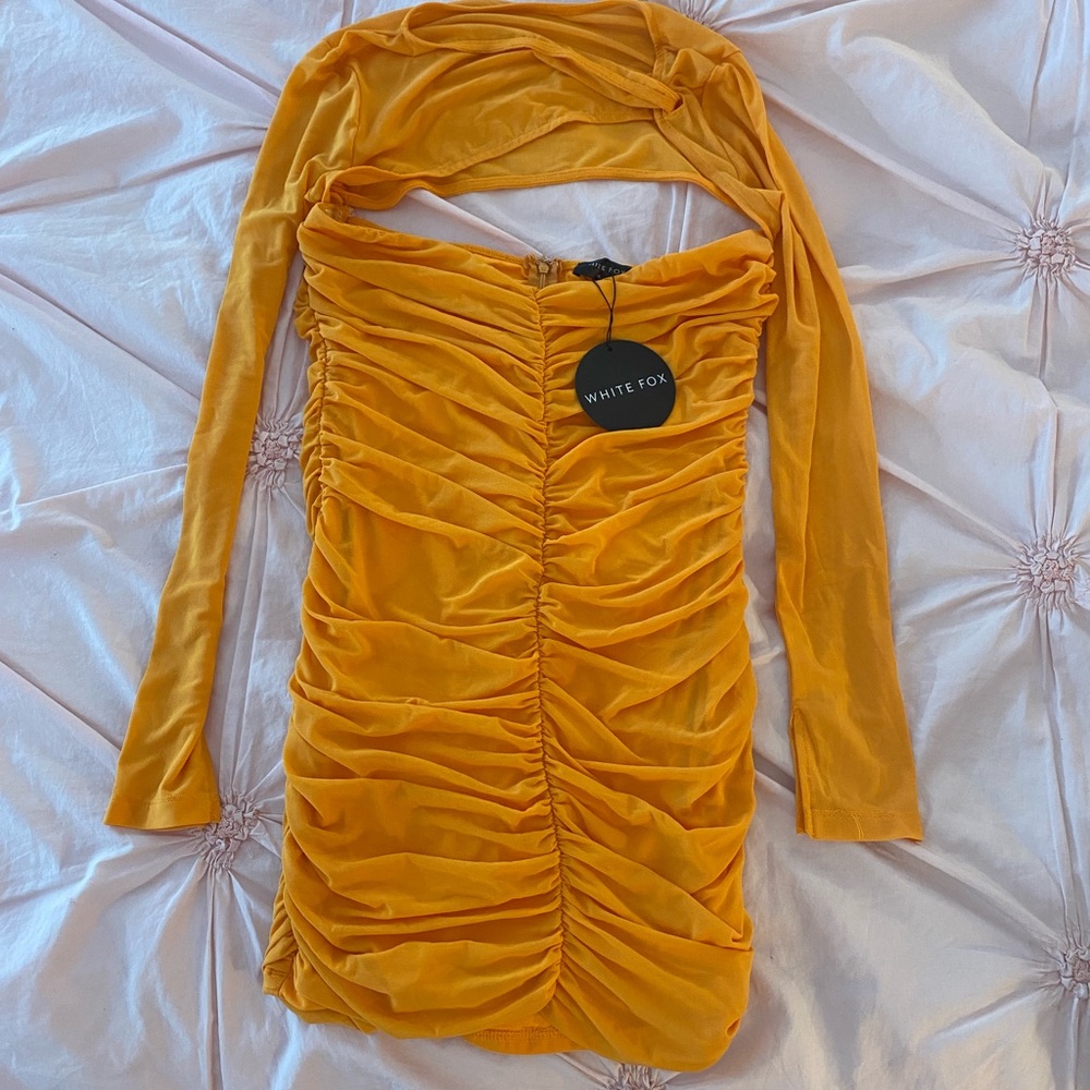 Orange mini dress with ruching and mesh sleeves.